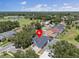 Aerial view showcases the property, surrounding greenery, and a nearby lake at 4401 Arranmore Cir, Valrico, FL 33596