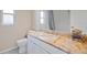 This bathroom features granite countertops, white cabinets, and tile floors at 4401 Arranmore Cir, Valrico, FL 33596