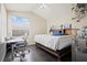This bedroom features a bed, desk, window, and hardwood floors at 4401 Arranmore Cir, Valrico, FL 33596