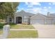 Charming single-story home with a well-manicured lawn and a three car garage at 4401 Arranmore Cir, Valrico, FL 33596