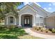 Charming single-story home with a well-manicured lawn and a double-door entrance at 4401 Arranmore Cir, Valrico, FL 33596