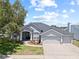 Charming single-story home with a well-manicured lawn and a three car garage at 4401 Arranmore Cir, Valrico, FL 33596