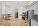Kitchen featuring stainless steel appliances, granite countertops, and white cabinets at 4401 Arranmore Cir, Valrico, FL 33596