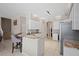 Modern kitchen with granite countertops, white cabinets, and stainless steel appliances at 4401 Arranmore Cir, Valrico, FL 33596