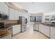 Bright kitchen features stainless steel appliances, granite countertops, and tile flooring at 4401 Arranmore Cir, Valrico, FL 33596