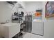 This laundry room provides shelving, a utility sink, and a washer and dryer at 4401 Arranmore Cir, Valrico, FL 33596