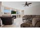 Living room boasting a fireplace, neutral paint, and lots of natural light at 4401 Arranmore Cir, Valrico, FL 33596