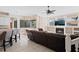 Open-concept living room featuring a fireplace, tile floors, and backyard views at 4401 Arranmore Cir, Valrico, FL 33596