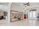 Bright living room featuring tile flooring, shelving, and views of the foyer and front entrance at 4401 Arranmore Cir, Valrico, FL 33596