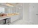 This main bathroom features white cabinets, a granite vanity, and a glass door shower at 4401 Arranmore Cir, Valrico, FL 33596