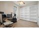 Bright office with built-in shelving, ceiling fan, and hardwood floors at 4401 Arranmore Cir, Valrico, FL 33596