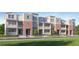 Charming townhome exterior with brick facade, white balconies, and well-manicured landscaping at 4511 S Manhattan Ave # 13, Tampa, FL 33611