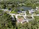 Scenic aerial view of home with lake, lush greenery, and neighborhood at 4549 Ontario Dr, New Port Richey, FL 34652