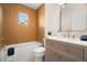 Stylish bathroom featuring a tub, wooden accent walls, and brushed gold hardware at 4549 Ontario Dr, New Port Richey, FL 34652