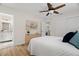 Comfortable bedroom featuring a ceiling fan, wood-look floors, and an ensuite bathroom at 4549 Ontario Dr, New Port Richey, FL 34652