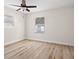 Bright, empty bedroom with a ceiling fan, two windows, wood look floors, and neutral colors at 4549 Ontario Dr, New Port Richey, FL 34652