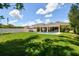 Inviting backyard features a sparkling pool and meticulously maintained lawn, perfect for outdoor enjoyment at 4918 Lakeshore Oaks Ct, Tampa, FL 33624