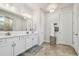 Bathroom featuring double sinks, white cabinets, and a glass-enclosed shower at 4918 Lakeshore Oaks Ct, Tampa, FL 33624