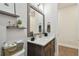 Modern bathroom with floating shelves, dark wood vanity, white counter, and framed mirror at 4918 Lakeshore Oaks Ct, Tampa, FL 33624