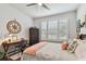 Comfortable bedroom featuring a cozy bed, plantation shutters, desk and ample natural light at 4918 Lakeshore Oaks Ct, Tampa, FL 33624