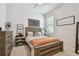 This bedroom has modern décor, a wooden bed frame, and a large window for natural light at 4918 Lakeshore Oaks Ct, Tampa, FL 33624