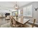 Dining room with an open view to the living room, filled with natural light from shuttered windows at 4918 Lakeshore Oaks Ct, Tampa, FL 33624