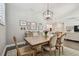 Dining area with wooden table and chairs, stylish rug, and a view to the open-concept kitchen at 4918 Lakeshore Oaks Ct, Tampa, FL 33624