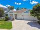 Charming home with a three-car garage, complemented by lush landscaping and a well-manicured lawn at 4918 Lakeshore Oaks Ct, Tampa, FL 33624