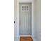 Classic front door with a welcome mat, sidelights, and modern hardware, offering a warm invitation at 4918 Lakeshore Oaks Ct, Tampa, FL 33624