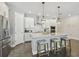 Modern kitchen featuring an island with seating, stainless steel appliances, and white cabinets at 4918 Lakeshore Oaks Ct, Tampa, FL 33624