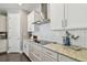 Modern kitchen with stainless appliances, white cabinets, and stylish backsplash at 4918 Lakeshore Oaks Ct, Tampa, FL 33624