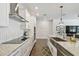 Gourmet kitchen features stainless appliances, granite countertops, and tiled backsplash at 4918 Lakeshore Oaks Ct, Tampa, FL 33624