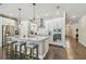 Modern kitchen featuring an island with seating, stainless steel appliances, and white cabinets at 4918 Lakeshore Oaks Ct, Tampa, FL 33624