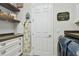 Functional laundry area with shelving, cabinetry, and side-by-side washer and dryer at 4918 Lakeshore Oaks Ct, Tampa, FL 33624