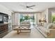 Spacious living room with hardwood floors and sliding glass doors leading to the pool at 4918 Lakeshore Oaks Ct, Tampa, FL 33624