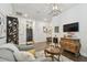 Stylish living room with hardwood floors, tv, and built-in desk area at 4918 Lakeshore Oaks Ct, Tampa, FL 33624