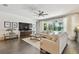 Comfortable living room with hardwood floors, TV, and sliding glass doors to backyard at 4918 Lakeshore Oaks Ct, Tampa, FL 33624