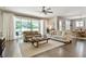 Bright living room with hardwood floors, neutral decor, and sliding doors to the outside at 4918 Lakeshore Oaks Ct, Tampa, FL 33624