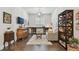 Living room with hardwood floors, sofa, built-in desk, and decorative bookcase at 4918 Lakeshore Oaks Ct, Tampa, FL 33624