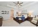 Main bedroom features tray ceilings, ceiling fan, and two night stands with lamps at 4918 Lakeshore Oaks Ct, Tampa, FL 33624