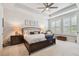 Spacious main bedroom with tray ceiling, ceiling fan, and natural light from the shuttered windows at 4918 Lakeshore Oaks Ct, Tampa, FL 33624