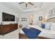 Main bedroom featuring a TV, ceiling fan, and decorations on the wall at 4918 Lakeshore Oaks Ct, Tampa, FL 33624