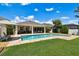 Outdoor view of the backyard pool and patio, a great space for relaxation and entertaining in this lovely home at 4918 Lakeshore Oaks Ct, Tampa, FL 33624