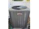 A close-up of a Lennox AC unit, showcasing its features and the surrounding gravel bed at 50 Water Oak Way, Oldsmar, FL 34677