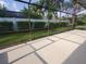 Spacious backyard features a white privacy fence and large screened-in patio area at 50 Water Oak Way, Oldsmar, FL 34677