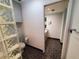 Bathroom featuring a glass block wall and dark tile flooring at 50 Water Oak Way, Oldsmar, FL 34677