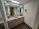 Bathroom featuring ample vanity space, dark tile flooring, and ample mirrors at 50 Water Oak Way, Oldsmar, FL 34677
