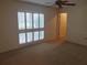 Bright bedroom features a ceiling fan and a window with stylish white shutters at 50 Water Oak Way, Oldsmar, FL 34677