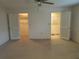 Bedroom featuring neutral carpet and walk-in closets with ventilated doors at 50 Water Oak Way, Oldsmar, FL 34677