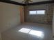 Bedroom featuring tile flooring and large window with blinds at 50 Water Oak Way, Oldsmar, FL 34677